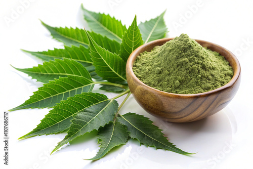 Herbalneem leaves with powder in a wooden bowl, isolated on white background