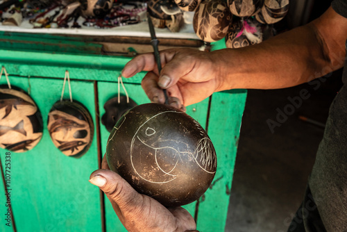 Peruvian jungle artisan working on his products to sell them in his market stall. photo