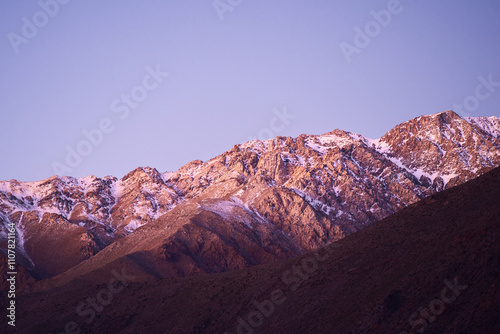 Rocky mountains with snow at the top on a sunset