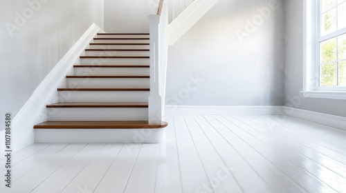 A bright, modern interior featuring a staircase with wooden steps and white railing, highlighting elegance and architectural design in home structures.