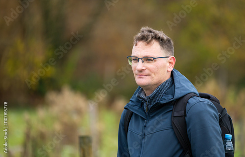 Outdoor portrait of a 45 yo white hiking man in an autumn forest in Oud-Heverlee, Belgium photo