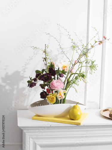 arrangement of flowers in kenzan in a bright interior. classic elegant style