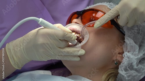 Closeup of the dentist's hands, which performs a professional oral hygiene procedure.Concept of dentistry and dentistry