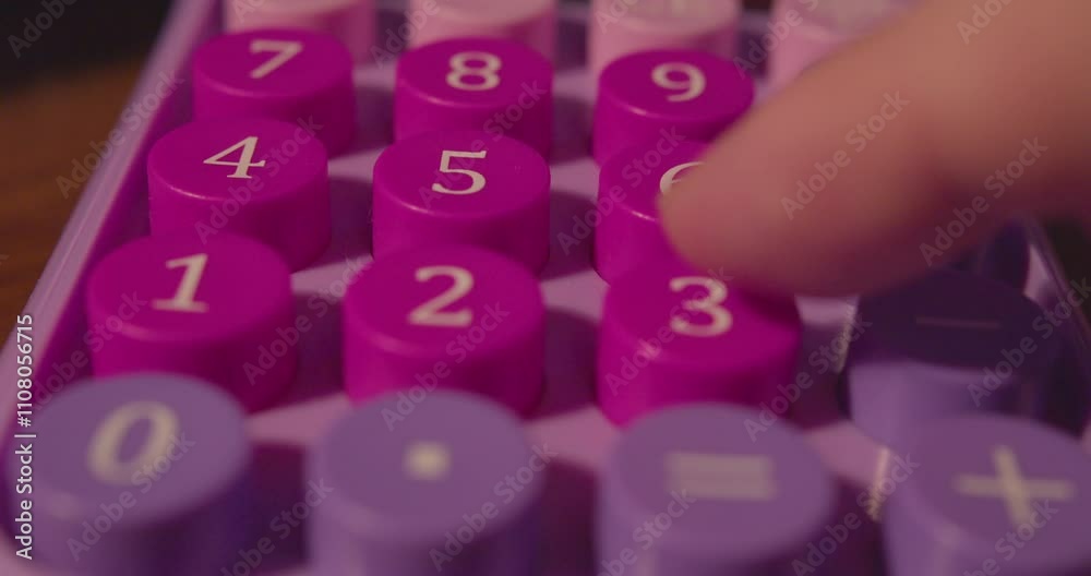 Hand of a businessman making a calculation on a calculator. Calculator buttons and finger close-up. Shallow depth of field.