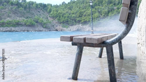 Sea level rising flooding bench on promenade