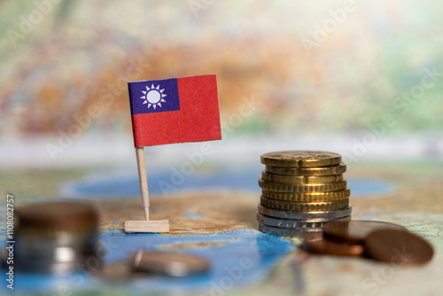 taiwanese flag with stacked coins on a world map, representing taiwan’s economy, financial system, and global trade impact photo