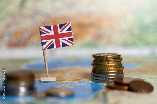 british flag with stacked coins on a world map, symbolizing the economy, financial system, and trade of the united kingdom
