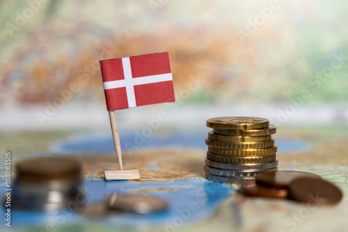 danish flag with coins on a map, representing economy, finance, wealth, currency, investment, trade, prosperity, global market, growth photo