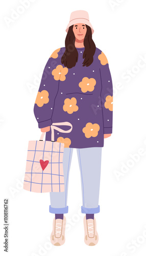 A fashionable girl in panama with a checkered shopping bag.Modern casual, hipster clothes