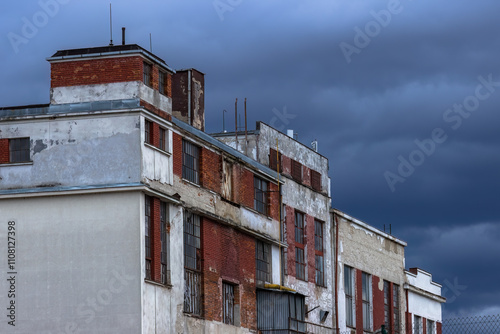 Fotografie Brick facade of an old abandoned industrial building.