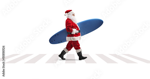 Photography Santa claus walking at a pedestrian crossing and carrying a surfboard