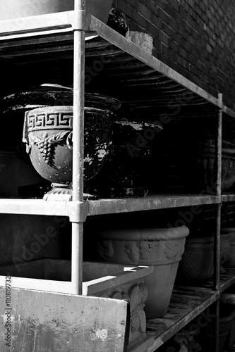 Planters lined up on storage shelves in the alley between stores in Ringgold, Georgia photo