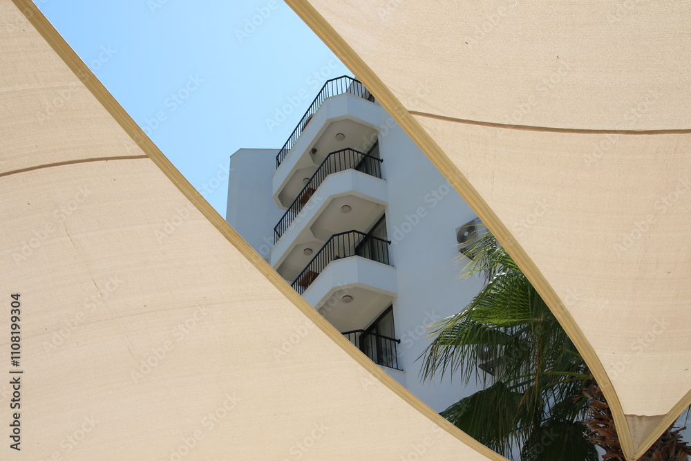 Summer vibes: A modern building with a shade sail providing shade and shelter from the sun