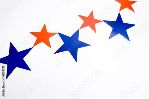 Red blue stars decor on light background. Copy space, minimalist style, festive background for design