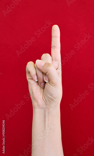 Hand with one finger up gesture with a a red background