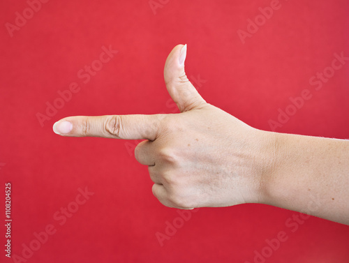 Hand gesture pointing with a red background