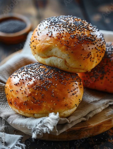 Three pikelets with black seeds on top of a wooden table photo