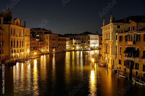 Venice, Italy: Night view of Venice Grand Canal with boats and Santa Maria della Salute church on sunset from Ponte dell'Accademia bridge. Venice, Italy photo