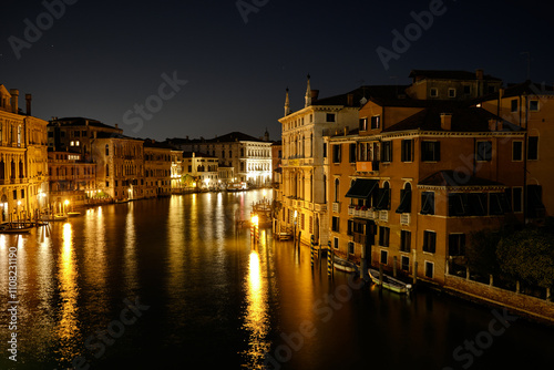 Venice, Italy: Night view of Venice Grand Canal with boats and Santa Maria della Salute church on sunset from Ponte dell'Accademia bridge. Venice, Italy