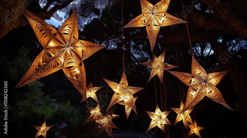 Many large star-shaped lights hang from trees. Decorative lights golden, intricate. Look like beautiful, hand-made paper stars. Create magical night ambiance. Maori New Year celebration. Night scene.