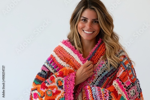 Cheerful woman in colorful blanket with bright smile and warm vibe photo