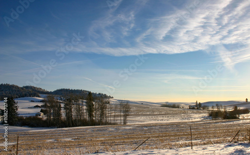 photo of light snow in the farm fields near Southwick Id backed with a beautiful winter sky