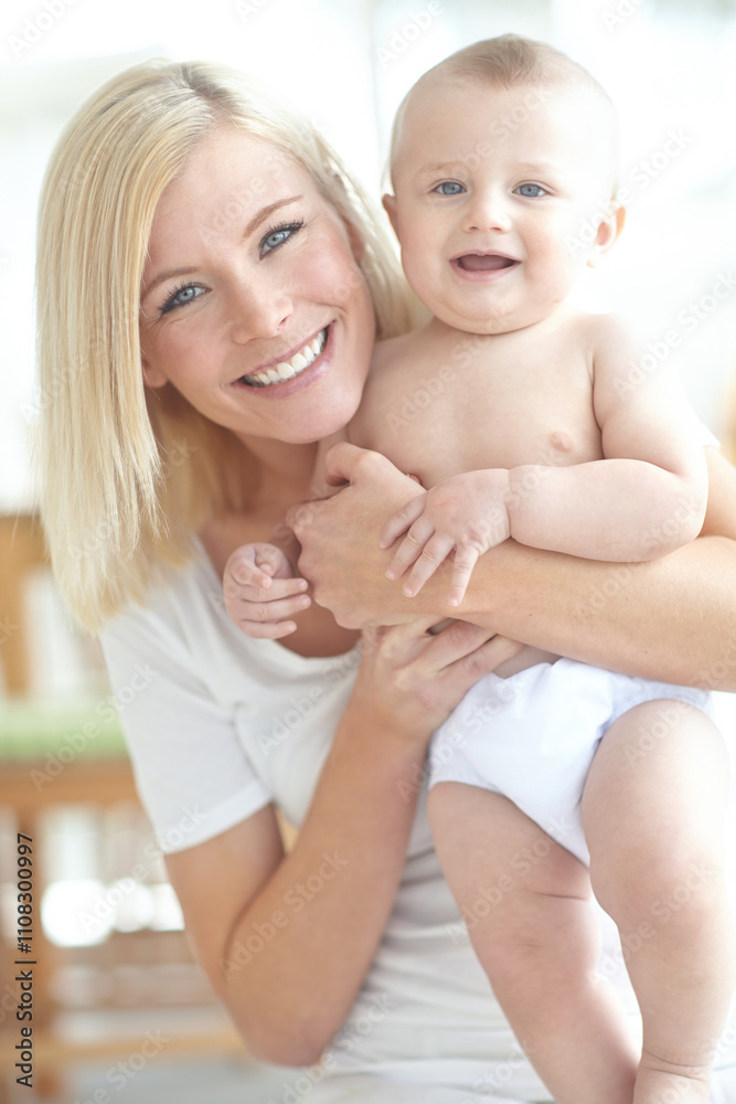 Mom, infant and smile at apartment with bonding for love, care and support with pride for motherhood. People, parent and happy with kid or baby at home for fun, safety and child development or growth Mom, infant and smile at apartment with bonding for love, care and support with pride for motherhood. People, parent and happy with kid or baby at home for fun, safety and child development or growth