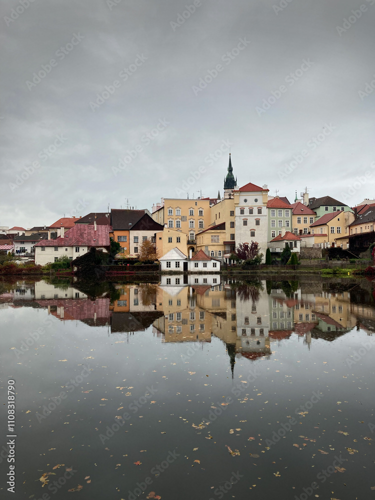 Charming reflection of colorful traditional houses in Jindřichův Hradec, Czech Republic. A serene autumn scene capturing the quaint architecture and calm waters of this picturesque town Charming reflection of colorful traditional houses in Jindřichův Hradec, Czech Republic. A serene autumn scene capturing the quaint architecture and calm waters of this picturesque town