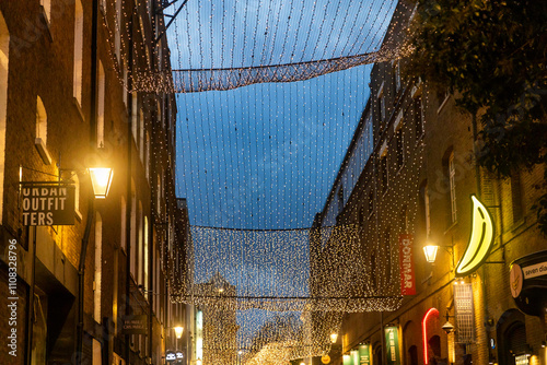 London, UK, November 22, 2024. Illuminations at dusk on Seven Dials street. Christmas light photo