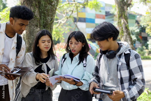 Group Of Young Asian College Students Studying Together Outside The College Building photo