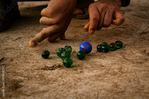 Kids playing marbles, Kanche Game, Peshawar culture, Indian Kancha game, Kaanche, Child playing marbles.