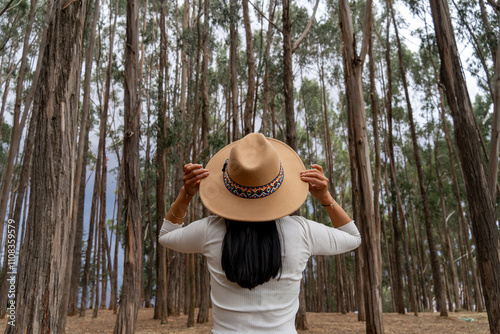 Young latina tourist enjoying the eucalyptus forest in qenqo cusco photo