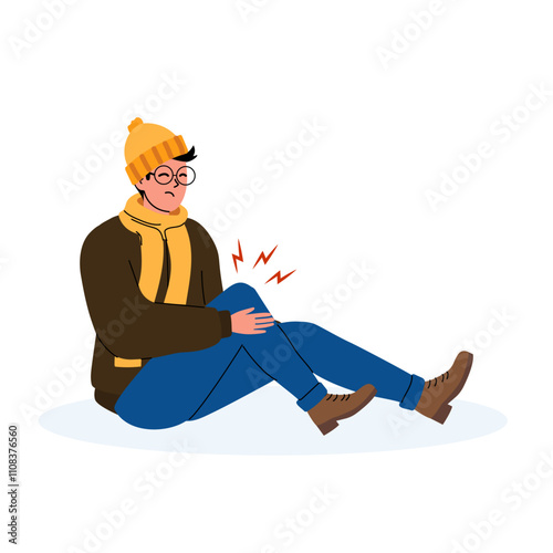 A young man sitting on the ground, experiencing knee pain while wearing a winter outfit