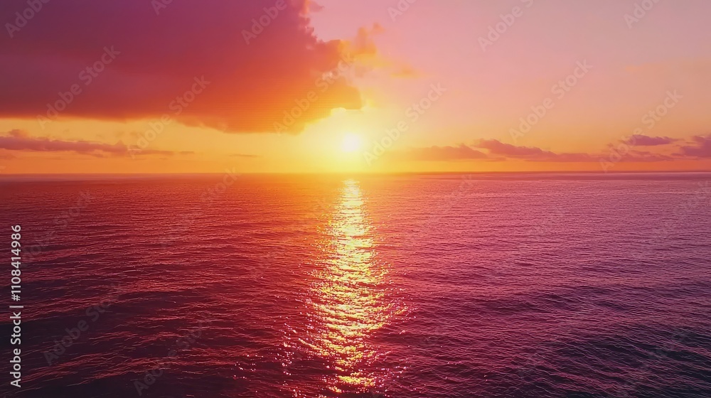Fototapeta premium Vivid Sunset Over a Calm Sea with Bright Orange and Pink Hues Cast Across the Water, Creating a Serene and Peaceful Atmosphere at Dusk
