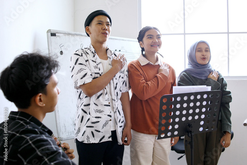 Diverse Asian High School Students Practice Singing Together In Choir Class photo