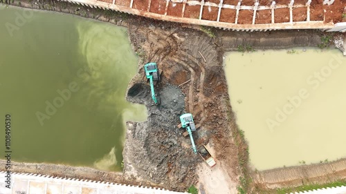 Drone Shot Over Two Escavators working inside Dam Contruction
