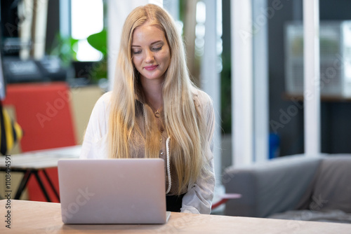 Free Download Beautiful woman with blond hair using with computer laptop at office table. professional freelancer in workplace. - GFXLoad