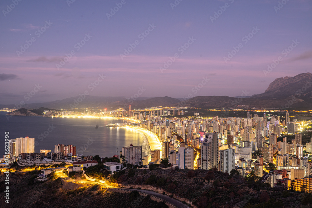 Sunrise on a clear day over Benidorm in Spain from the Mirador de la Cruz