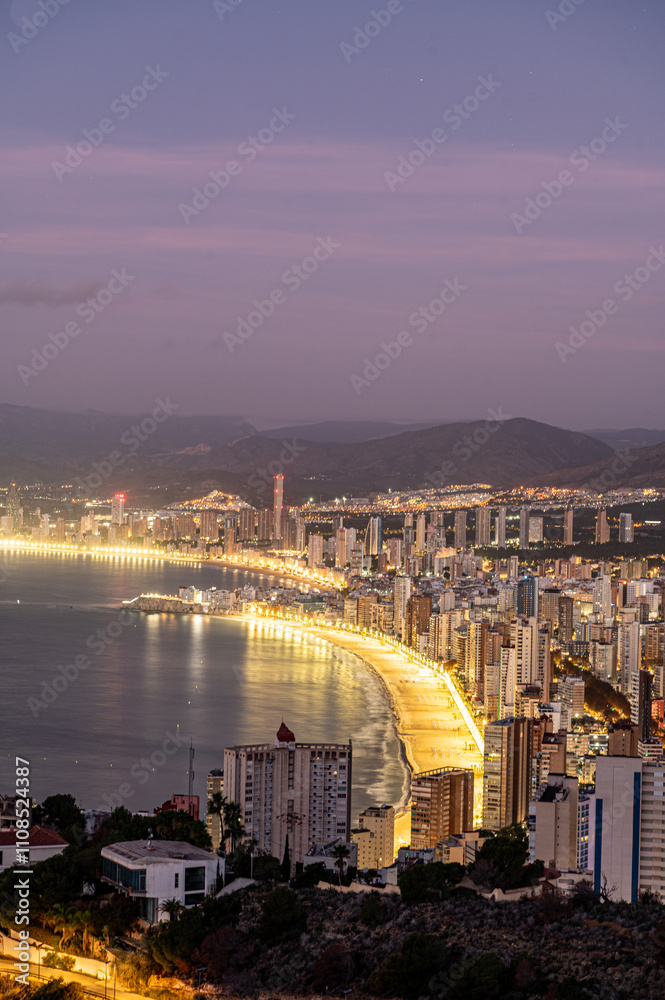 Sunrise on a clear day over Benidorm in Spain from the Mirador de la Cruz