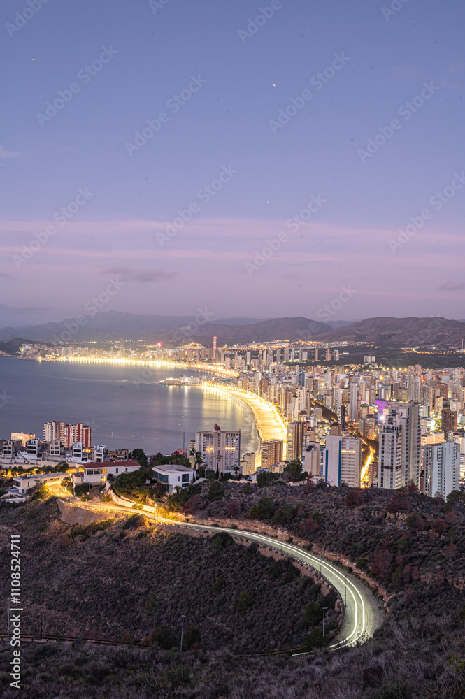 Sunrise on a clear day over Benidorm in Spain from the Mirador de la Cruz