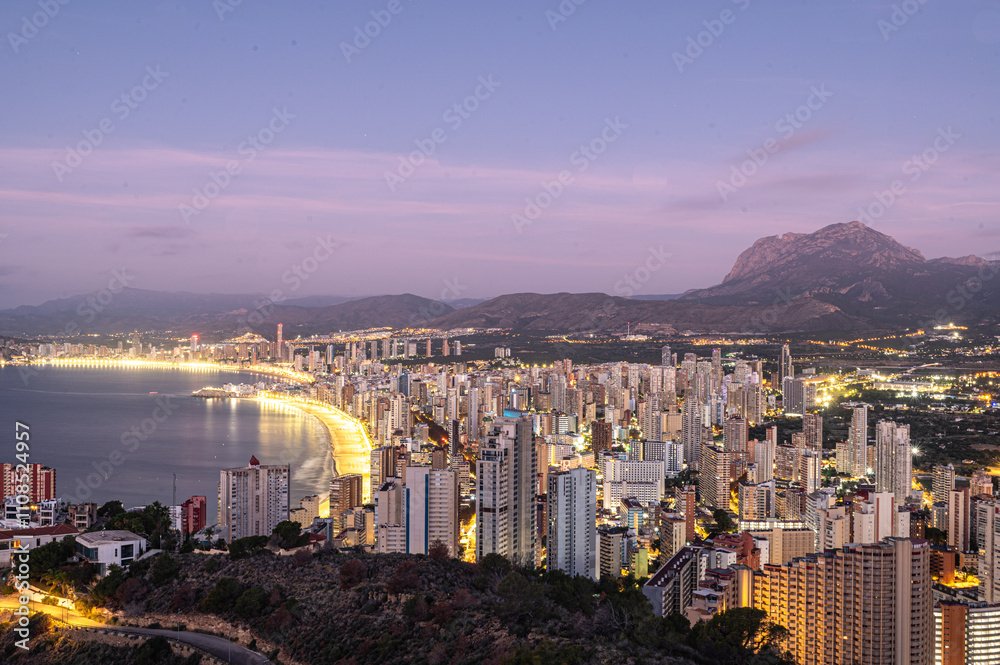 Sunrise on a clear day over Benidorm in Spain from the Mirador de la Cruz