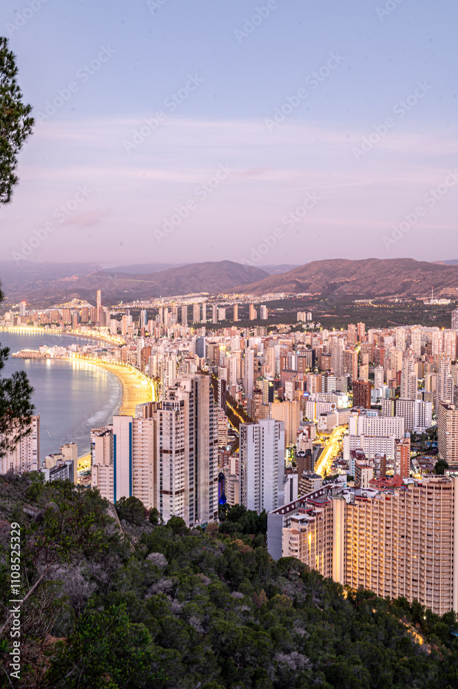 Sunrise on a clear day over Benidorm in Spain from the Mirador de la Cruz