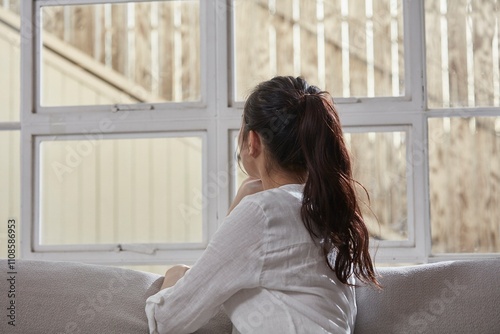 A woman resting in front of a big window for the holidays Free Download A woman resting in front of a big window for the holidays - GFXLoad