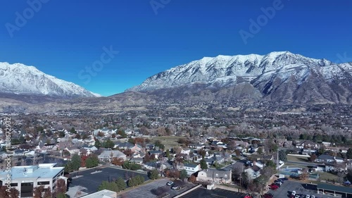 Aerial Residential to retail shopping mall valley Utah. Orem city, variety of stores businesses. Urban economy Malls, stores, residential neighborhoods, parks. High desert valley. Snow covered winter. photo