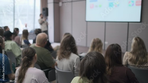 Wallpaper Mural Diverse group of people attentively listening to a speaker at a conference, emphasizing learning and collaboration in a professional environment. Torontodigital.ca