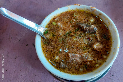 Pullubasa is a typical meal from the city of Makassar, Indonesia, in a white bowl ready to be eaten photo