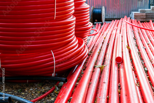 new red plastic conduit pipes in outdoor warehouse photo