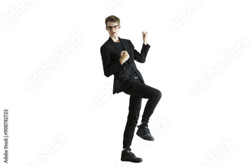 Man in a dynamic celebratory pose wearing asuit and glasses, standing on one leg, isolated on a white background, concept of success photo