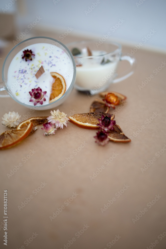 Fototapeta premium Candle in a mug with orange, plain background