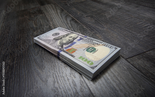 Side view small stack of US dollars on black boards